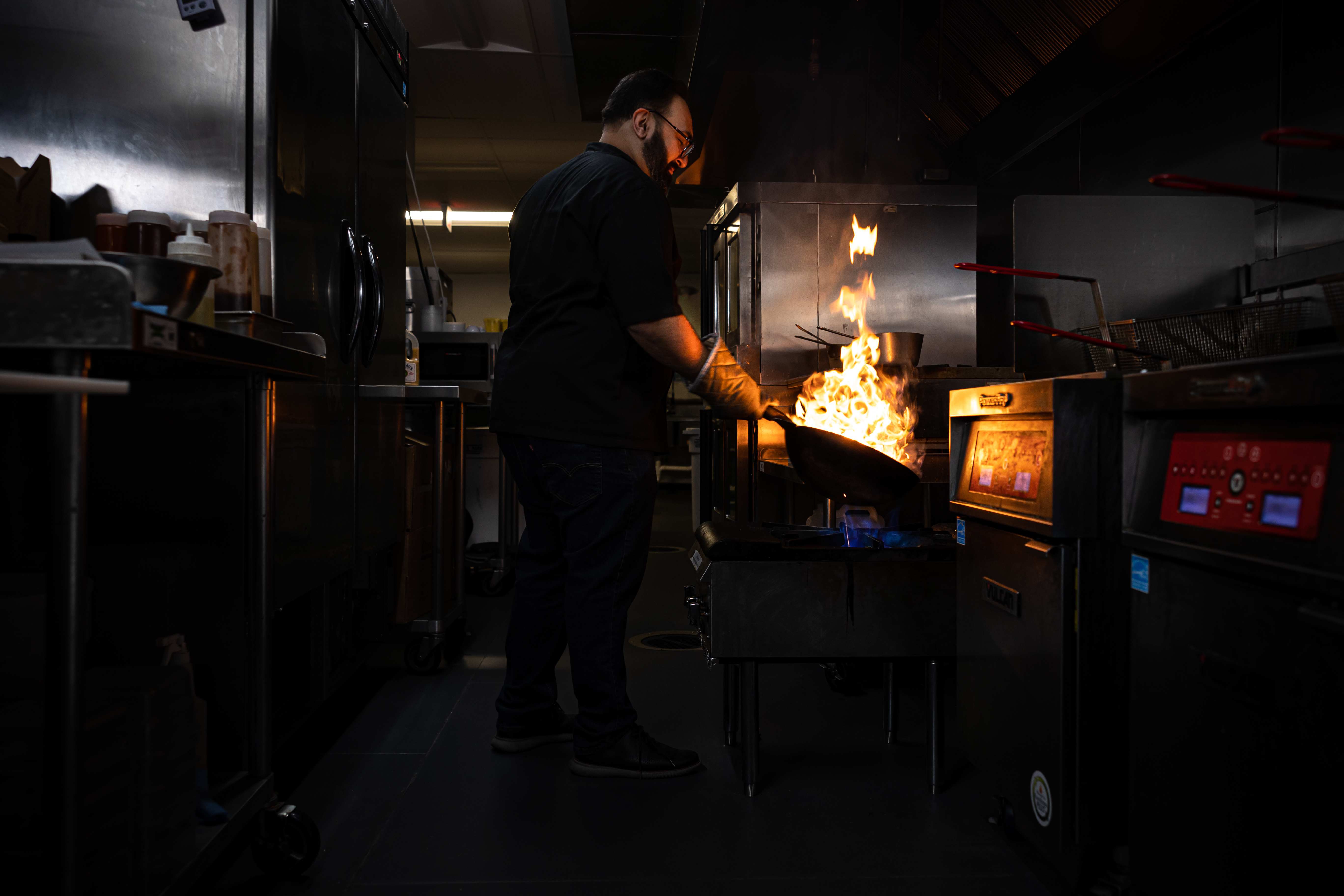 Chef cooking with open flames in the VXK kitchen